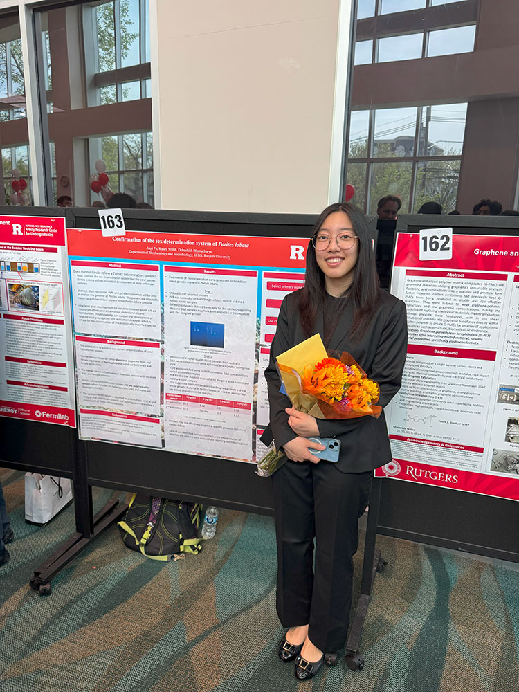 Jiayi Pu standing next to her poster
