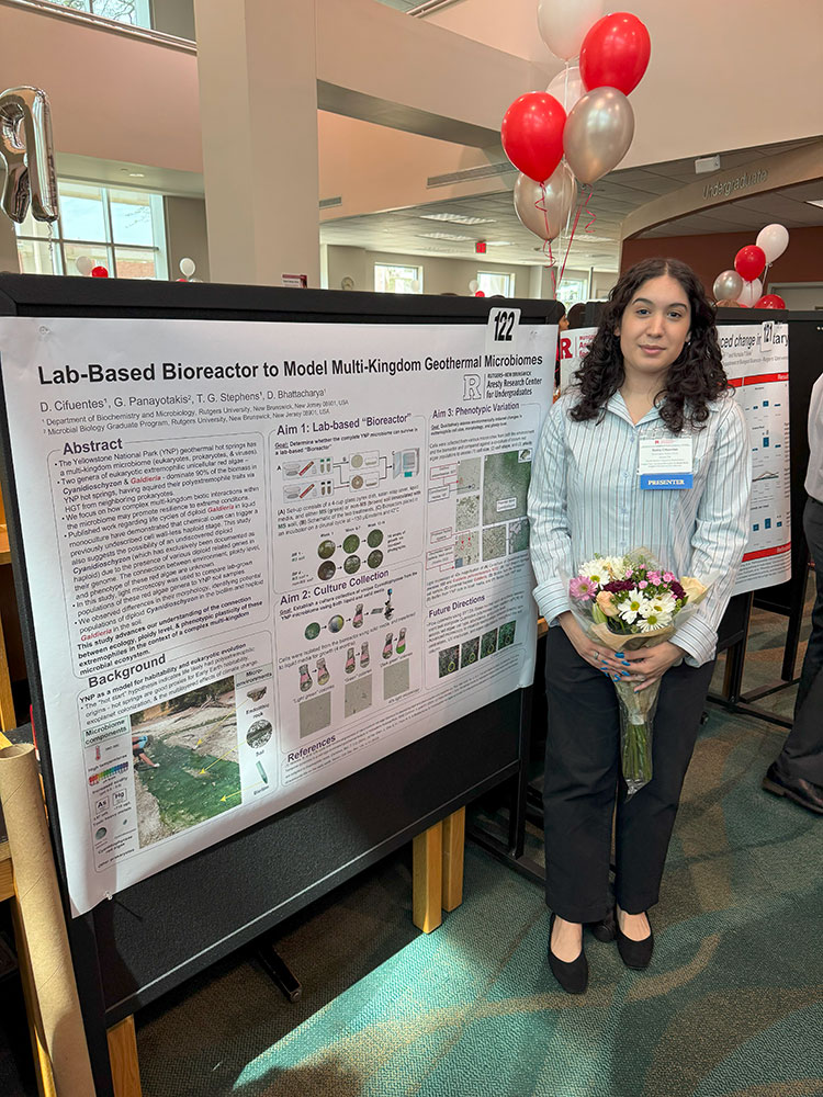 Daisy Cifuentes standing next to her poster